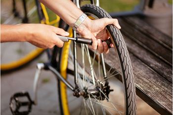 A person is fixing a bicycle tire.